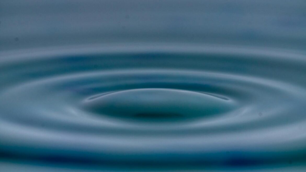 A detailed view of concentric water ripples creating a tranquil and serene effect.