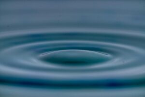 A detailed view of concentric water ripples creating a tranquil and serene effect.